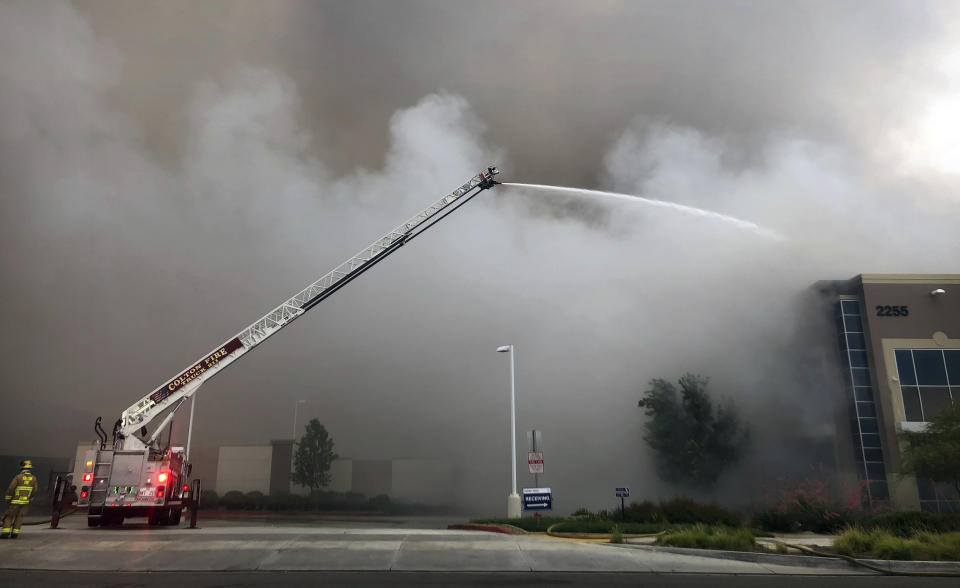 Firefighters from multiple agencies battle a warehouse fire in Redlands, Calif., on Friday, June 5, 2020. The destroyed a huge commercial building, about 60 miles east of Los Angeles, but there are no reports of injuries. (Watchara Phomicinda/The Orange County Register via AP)