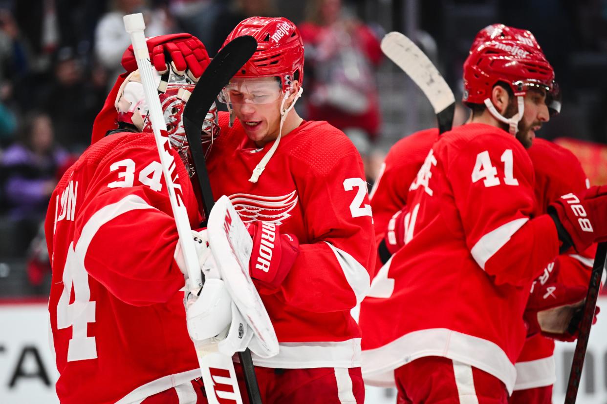 Red Wings goaltender Alex Lyon and left wing Lucas Raymond celebrate after the Wings' 4-0 win over the Devils on Wednesday, Nov. 22, 2023, at Little Caesars Arena.