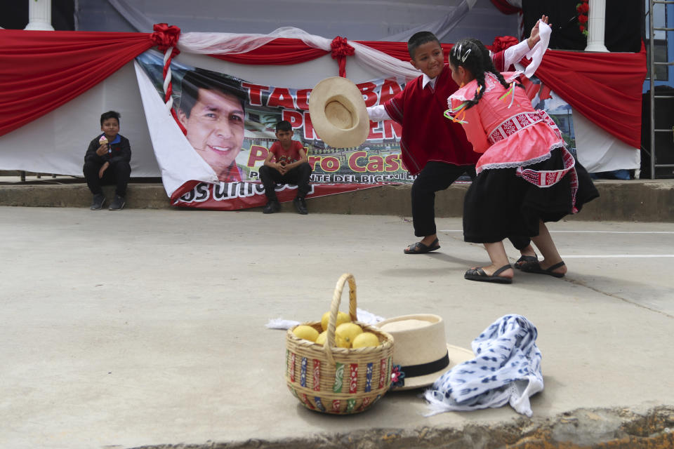 Young supporters of the new President Pedro Castillo dance on his inauguration day after watching his swearing-in ceremony via live broadcast on a screen set up in Tacabamba, Peru, located in the Cajamarca department where Castillo is from, Wednesday, July 28, 2021. (AP Photo/Francisco Vigo)