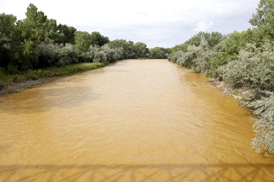 The discolored Animas River is seen with sludge flowing in it from the Gold King Mine spill on Aug. 8, 2015 at Berg Park in Farmington.