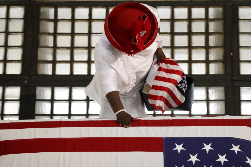 A mourner pauses by the casket of Rep. John Lewis lying in repose at the state capital, Wednesday, July 29, 2020, in Atlanta. Lewis, who carried the struggle against racial discrimination from Southern battlegrounds of the 1960s to the halls of Congress, died Friday, July 17, 2020. (AP Photo/Brynn Anderson)