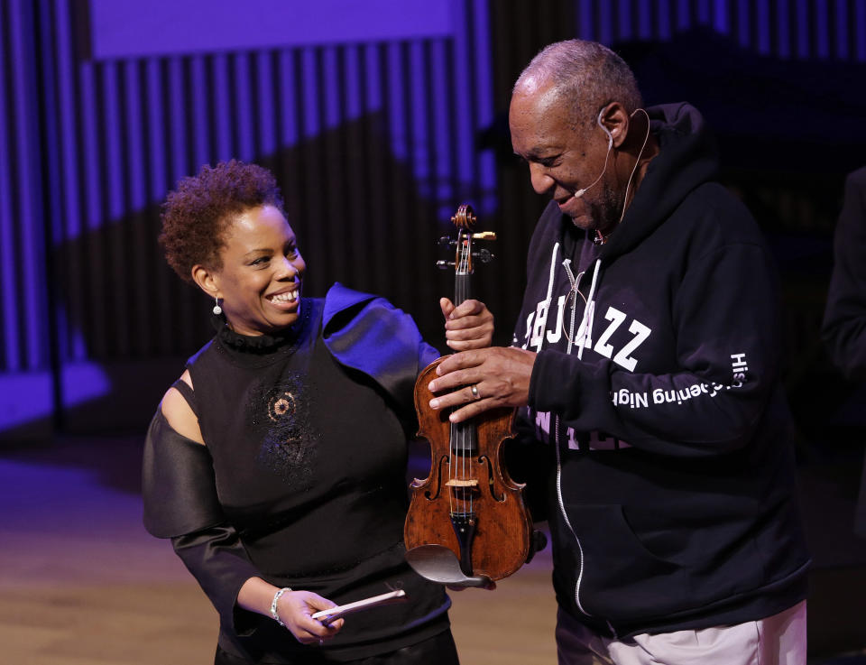 Bill Cosby, right, jokes with Regina Carter about her violin during the opening night concert of the SFJAZZ Center Wednesday, Jan. 23, 2013 in San Francisco. The 700-seat, specially designed concert hall nestled in the heart of the city's arts district attracted a crowd of hundreds with a high-energy, inaugural celebration emceed by Bill Cosby. Billed as the first freestanding building in the West built for jazz performance and education, the center opened Wednesday after raising more than $60 million over more than a decade to build a home for SFJAZZ, the nonprofit that puts on the city's jazz festival. (AP Photo/Eric Risberg)