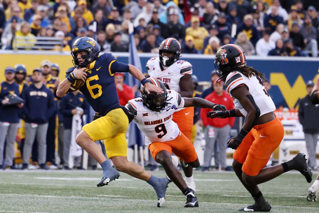 West Virginia quarterback Garrett Greene (6) carries the ball on a quarterback keeper during the second half of an NCAA college football game against Oklahoma State, Saturday, Oct. 21, 2023, in Morgantown, W.Va. (AP Photo/Chris Jackson)