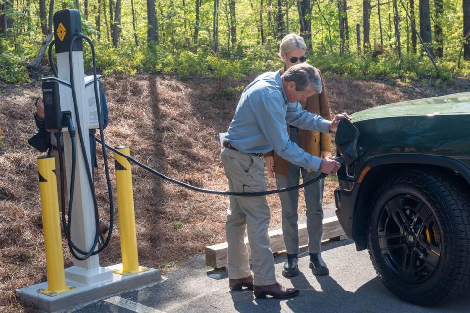 Gov. Brian Kemp plugs an electric vehicle into a new charger at Tallulah Gorge State Park in April 2023.