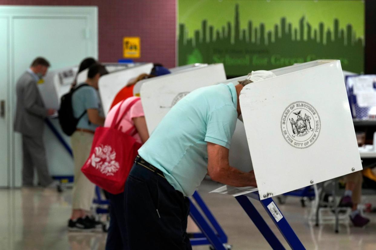 Voters mark their ballots at Frank McCourt High School, in New York, Tuesday, June 22, 2021. 