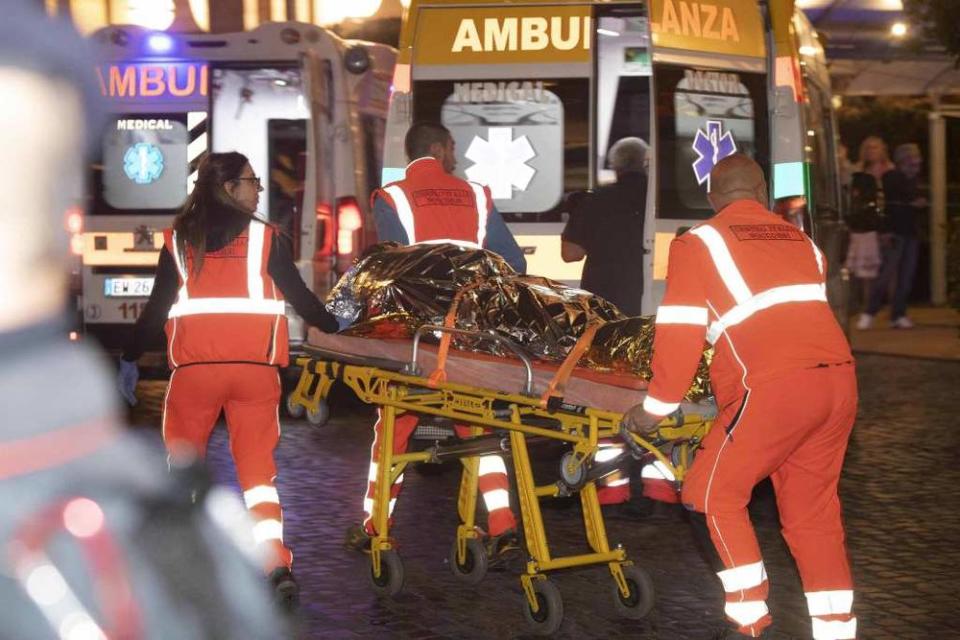 First responders loading an injured person into the ambulance