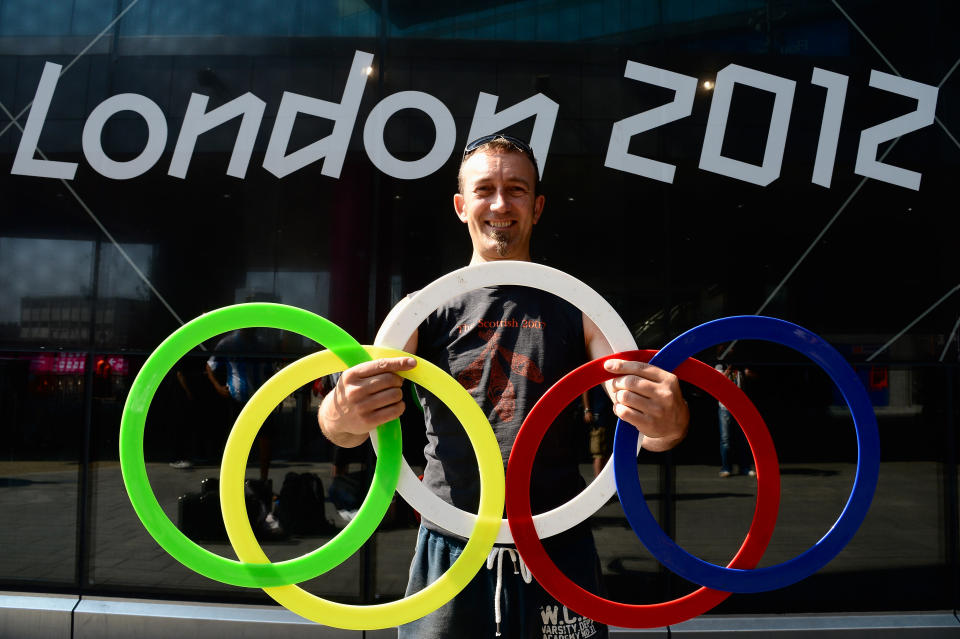 A Juggler poses with Olympic rings outside the Stratford Tube Station on July 26, 2012 in London, England. (Photo by Pascal Le Segretain/Getty Images)