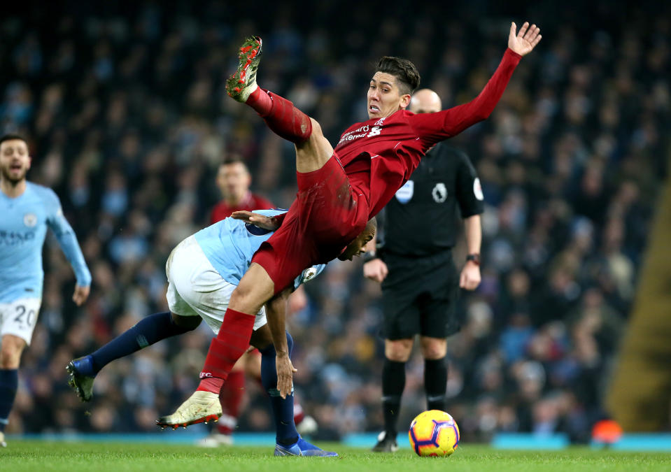 Liverpool’s Roberto Firmino (right) and Manchester City’s Fernandinho (left) battle for the ball