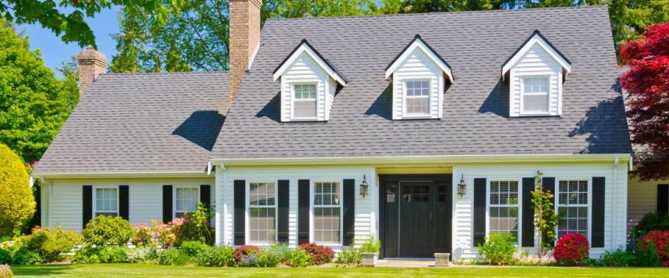 Custom built luxury house with nicely trimmed and landscaped front yard, lawn in a residential neighborhood. Vancouver Canada.