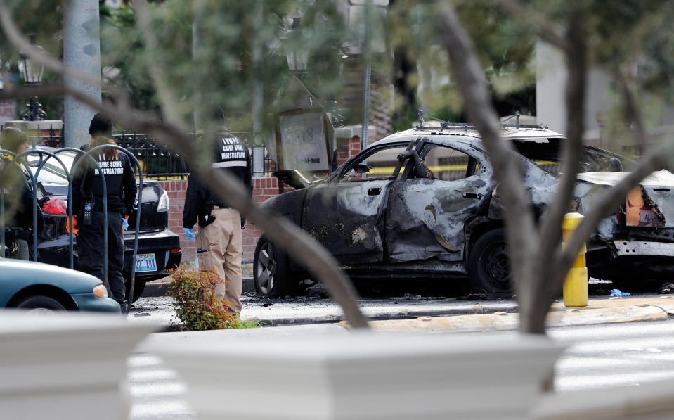 LAS VEGAS, NV - FEBRUARY 21: (EDITORS NOTE: Image contains graphic content.) A burned taxi cab sits at the site of what is being described as a gun battle between shooters in two vehicles along the Las Vegas Strip on February 21, 2013 in Las Vegas, Nevada. According to reports gunshots were fired between a black SUV and a Maserati, causing the Maserati to crash into a taxi that burst into flames. Five vehicles were involved in the subsequent crash with the Maserati driver and two people in the taxi being killed. (Photo by David Becker/Getty Images)