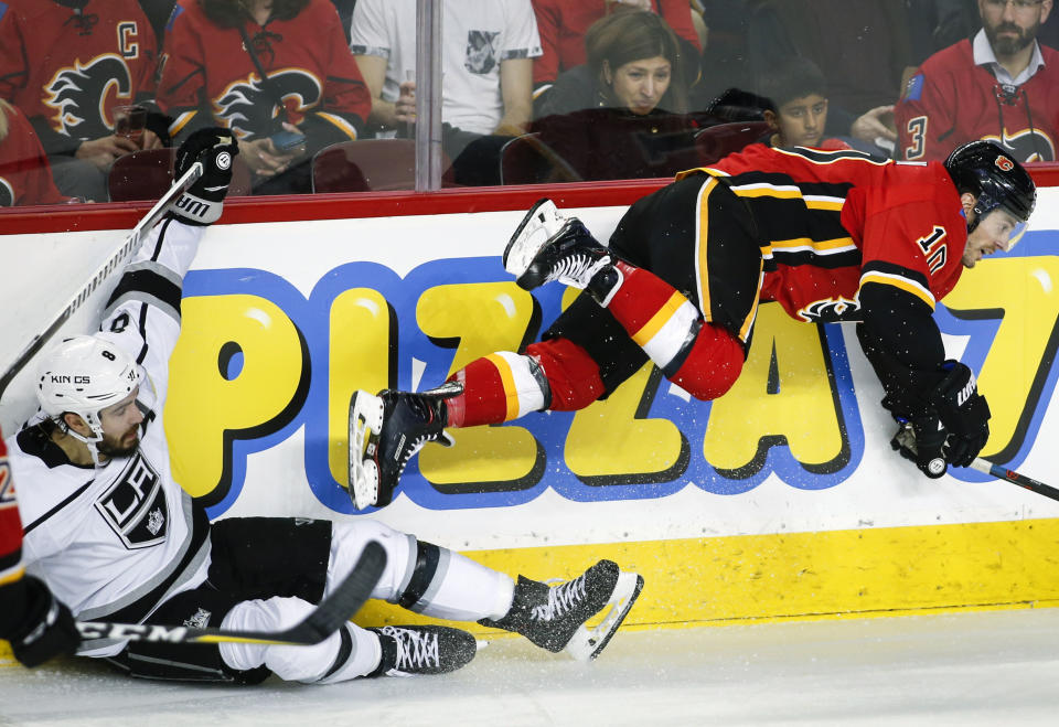 Los Angeles Kings' Drew Doughty, left, sends Calgary Flames' Derek Ryan flying during second-period NHL hockey game action in Calgary, Alberta, Monday, March 25, 2019. (Jeff McIntosh/The Canadian Press via AP)