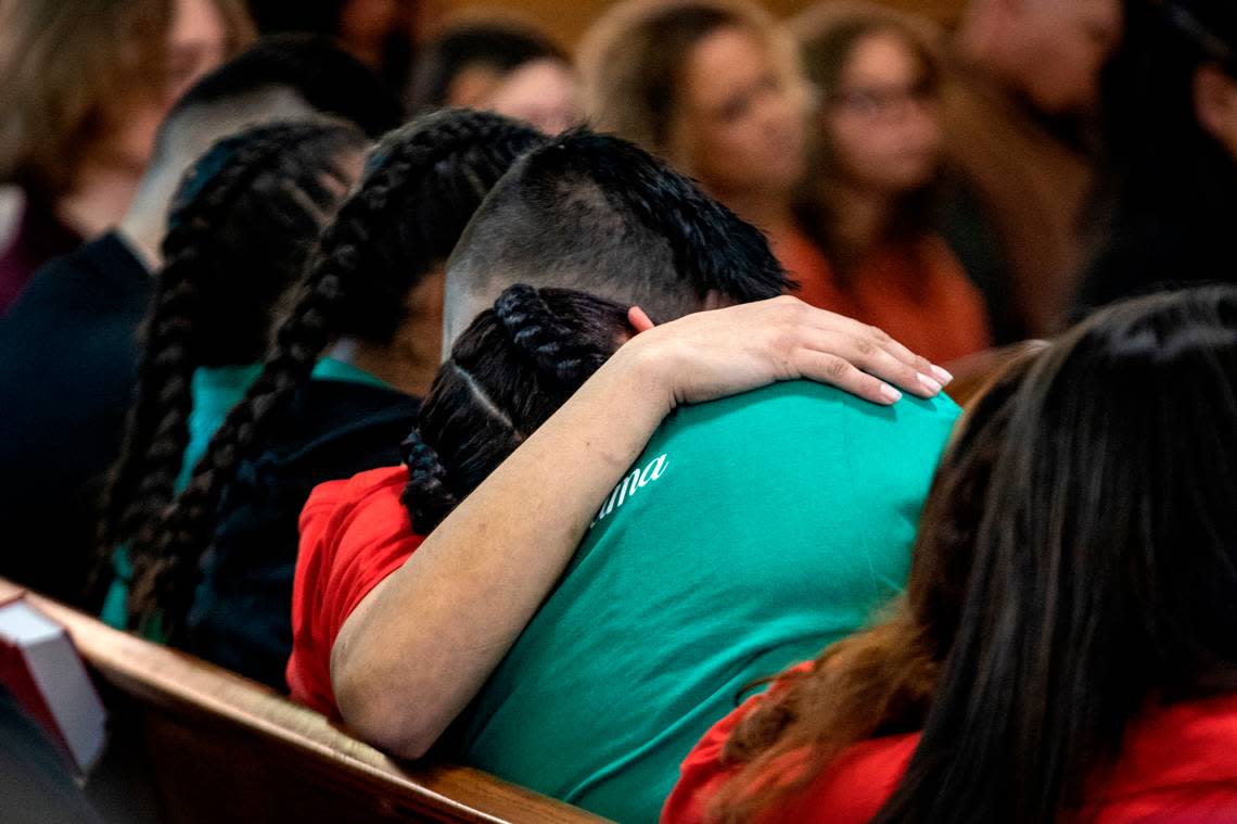 Erica Trevino is comforted by a family member during her son’s funeral in Waurika, Oklahoma, on Saturday, Jan. 28, 2023. Zechariah Trevino, killed by gun violence on Jan. 20, was remembered as a loving, funny person throughout the service.