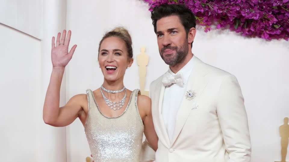 Emily Blunt wore a head-turning Schiaparelli gown with floating straps. She was pictured alongside husband John Krasinski in an off-white tuxedo. - Jordan Strauss/Invision/AP