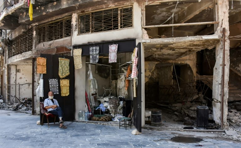 Mohammad Shawash sits outside his shop in the wartorn streets of Aleppo