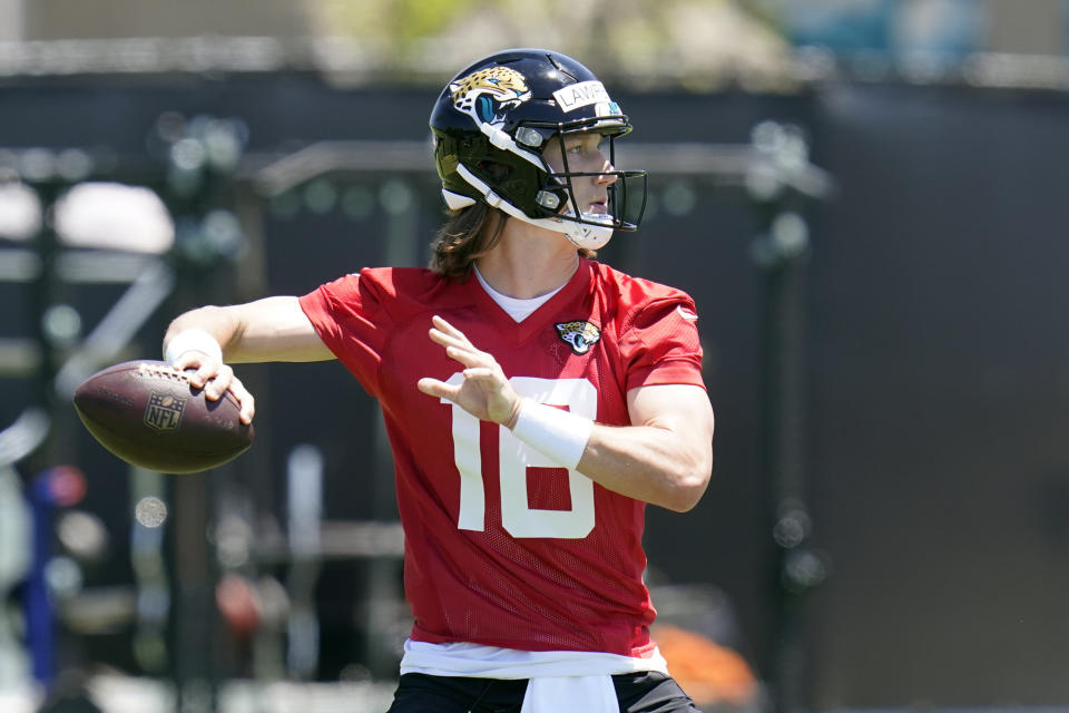 Jacksonville Jaguars quarterback Trevor Lawrence looks for a receiver during an NFL football rookie minicamp, Saturday, May 15, 2021, in Jacksonville, Fla. (AP Photo/John Raoux)