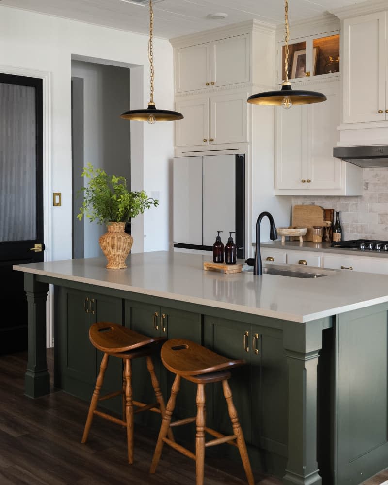 Green cabinets on kitchen island in newly renovated kitchen.