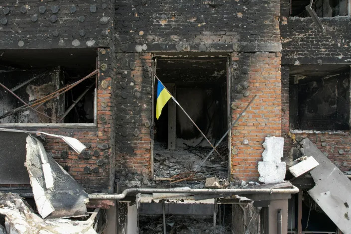 A Ukrainian flag is seen in an Irpin apartment building damaged in Russia&#39;s invasion of Ukraine.
