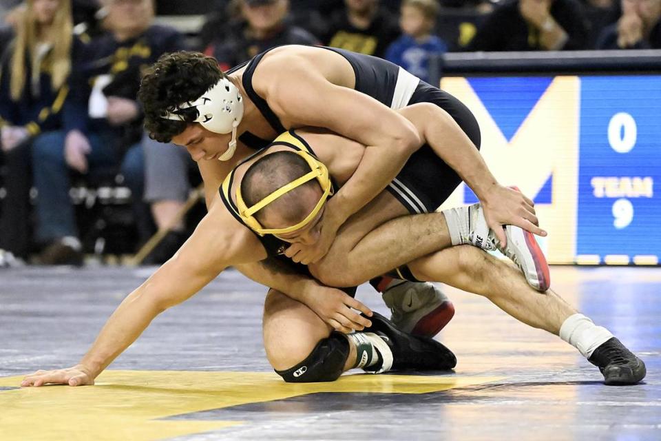 Penn State’s David Evans controls Michigan’s Fidel Mayora in their 149 pound bout of the Nittany Lions’ 27-9 win on Friday night in Ann Arbor, Mich. Evans topped Mayora, 5-2.