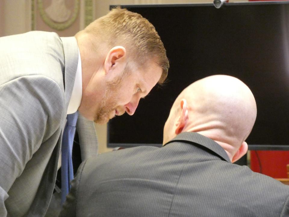 Crawford County assistant prosecutors Ryan Hoovler, left, and Dan Stanley confer during closing arguments in the trial of Robert Pinyerd on Friday in Crawford County Common Pleas Court.
