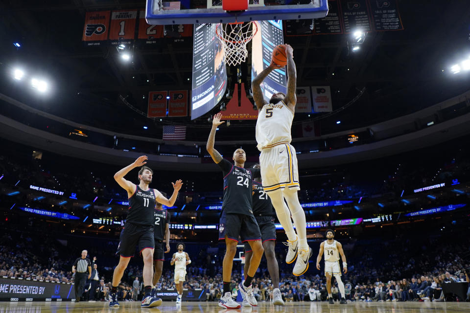 Villanova's Justin Moore, right, goes up for a dunk past UConn's Jordan Hawkins (24) during the second half of an NCAA college basketball game, Saturday, March 4, 2023, in Philadelphia. (AP Photo/Matt Slocum)