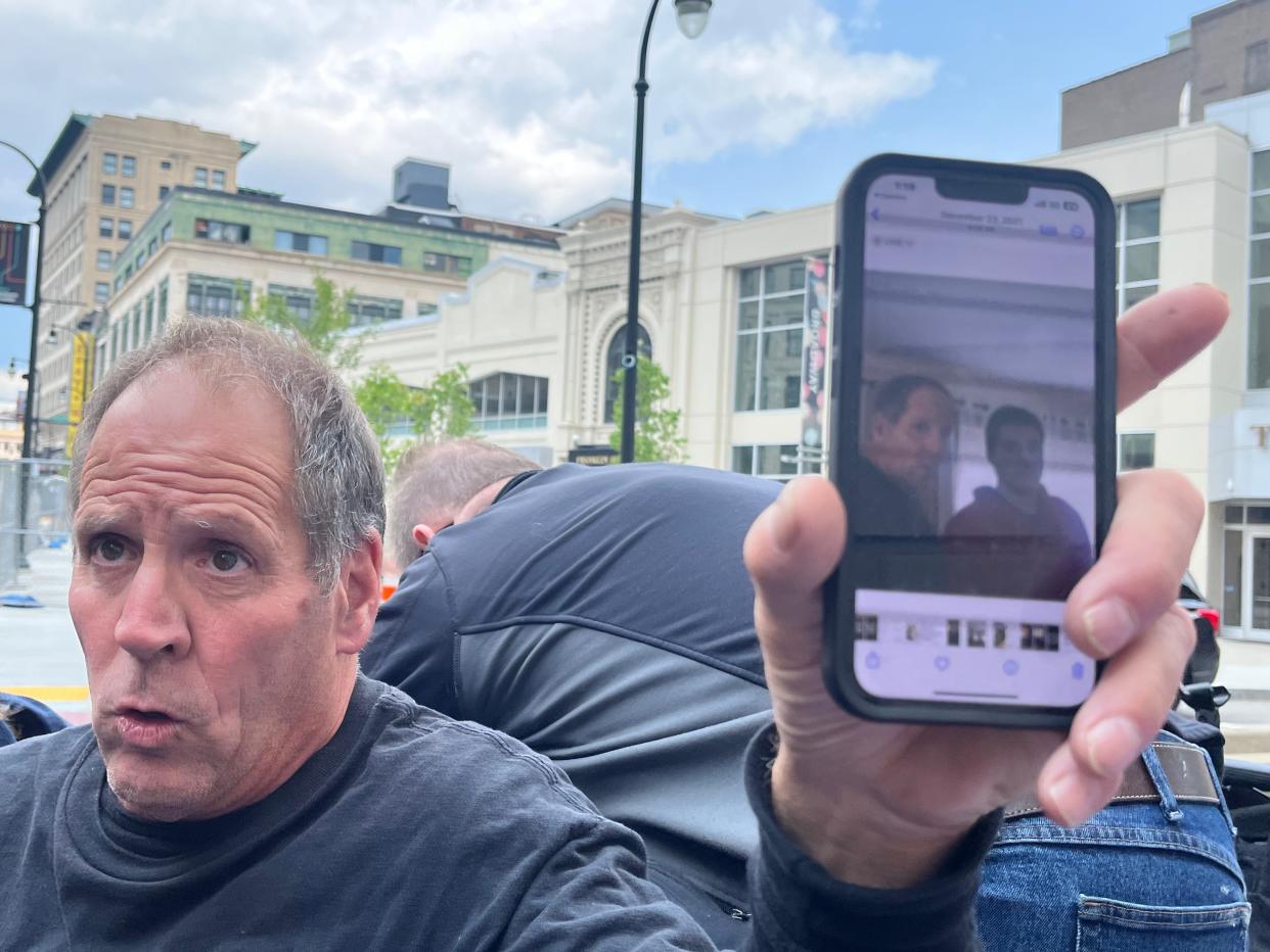 Paul Ventura, father of Mateo Ventura, shows a cellphone photo of himself with his son outside of federal court in Worcester on Thursday.