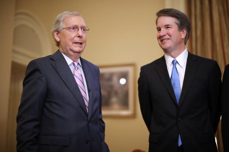 Senate Majority Leader Mitch McConnell (L) makes brief remarks before meeting with Judge Brett Kavanaugh (R) in McConnell's office in the US Capitol, in Washington, DC, on July 10,  2018. President Donald Trump nominated Kavanaugh to succeed retiring Supreme Court Associate Justice Anthony Kennedy.