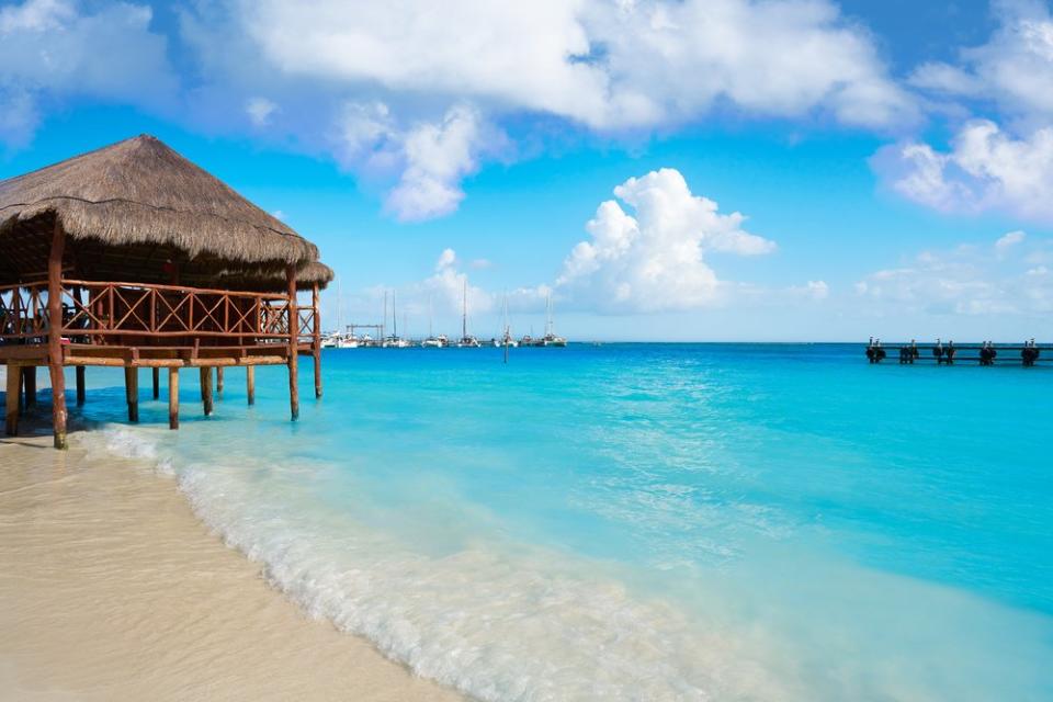 hut over aqua water in Punta Maroma Mexico