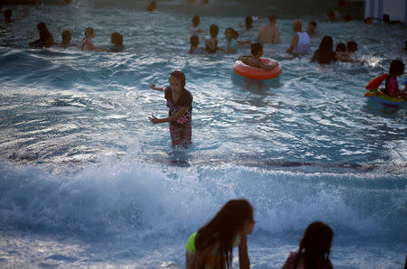 Palestinians swim at Sharm Park Water City, in Gaza July 9, 2018. REUTERS/Mohammed Salem