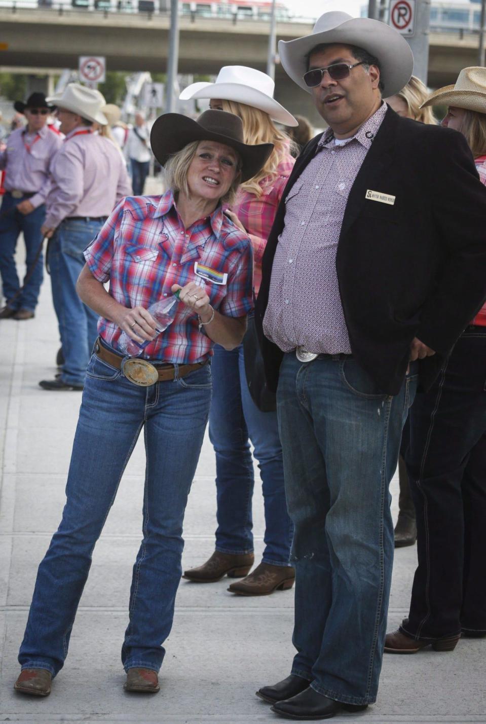 Calgary mayor Naheed Nenshi, right, and Alberta Premier Rachel Notley chat before the start of the Calgary Stampede parade in Calgary, Friday, July 8, 2016. THE CANADIAN PRESS/Jeff McIntosh