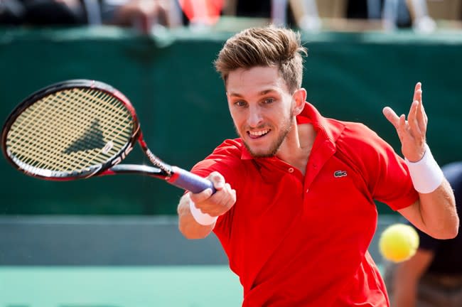 Peliwo returns the ball to Belgium's David Goffin during their Davis Cup World Group quarterfinals match in Middelkerke, Belgium, on Friday July 17 2015. (AP Photo/Geert Vanden Wijngaert)