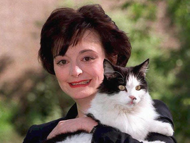 British Prime Minister's wife Cherie Blair poses with Humphery the cat 09 May in the garden of 10 Downing Street in London