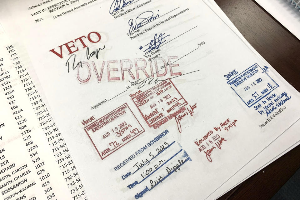 An override stamp is seen on legislation limiting LGBTQ+ classroom instruction in the early grades, after North Carolina state lawmakers override Democratic Gov. Roy Cooper's veto, Wednesday, Aug. 16, 2023, in Raleigh, N.C. The Republican-led General Assembly overrode the governor’s vetoes of the legislation and other bills touching on gender in sports and gender-affirming medical treatments. (AP Photo/Hannah Schoenbaum)