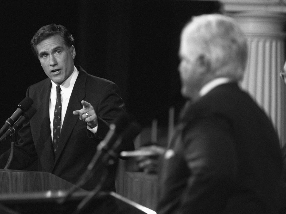 Mitt Romney makes a point to Senator Ted Kennedy during a debate.