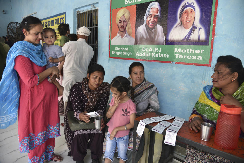 FILE- A volunteer prepares an oral re-hydration solution for a child as her parents wait to cast their votes on a hot summer day near Amritsar, India, Saturday, June 1, 2024. FILE- Laborers sleep by the side of a road on a hot night in Lucknow, India, Friday, June 14, 2024. A monthslong heatwave across swathes of India has killed more than 100 people and led to over 40,000 suspected cases of heat stroke in the last three and a half months, a Health Ministry official said Thursday, June 20. (AP Photo/Prabhjot Gill, file)