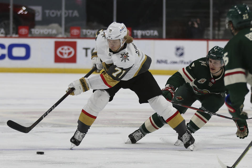 Vegas Golden Knights' William Karlsson (71) moves the puck downice against Minnesota Wild's Nico Strum (7) in the second period of an NHL hockey game Monday, March 8, 2021, in St. Paul, Minn. (AP Photo/Stacy Bengs)