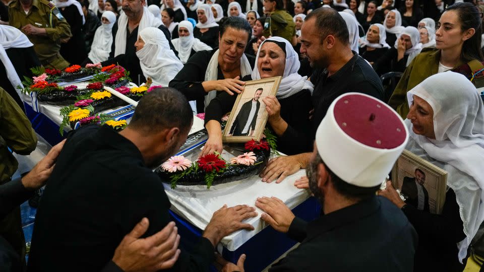 Mourners gather around the coffin of Druze Israeli Lt. Col. Salman Habaka in the village of Yanuh Jat, northern Israel, on November 3. Habaka was killed during a ground operation in the Gaza Strip. - Ariel Schalit/AP