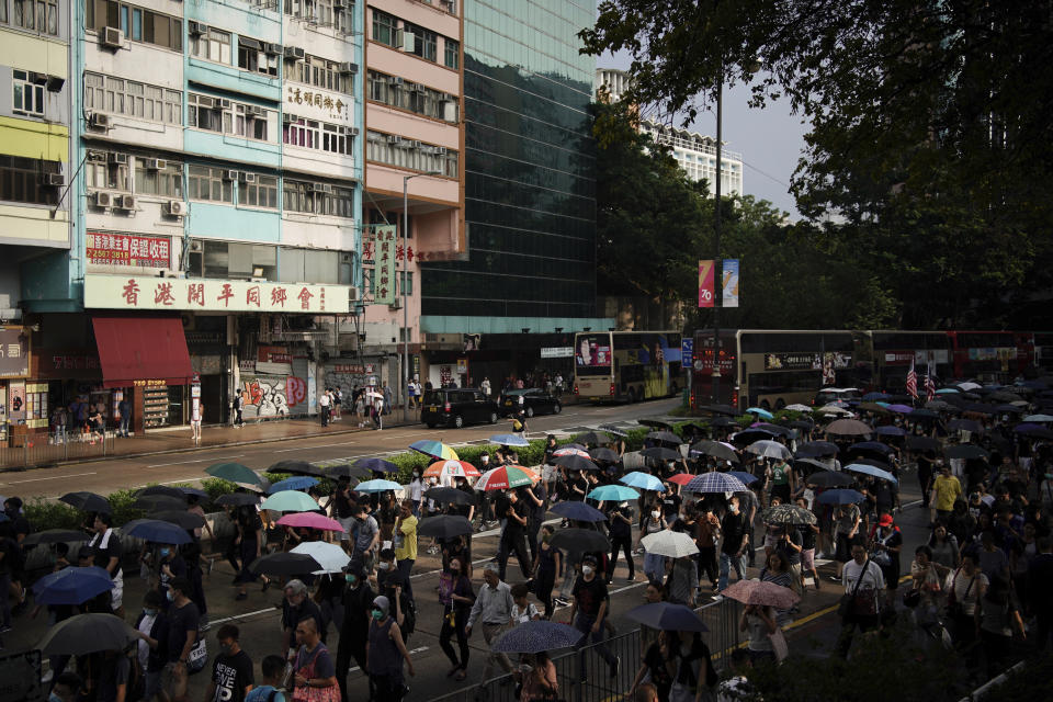 Protesters march on Nathan road during a protest in Hong Kong, Saturday, Oct. 12, 2019. The protests that started in June over a now-shelved extradition bill have since snowballed into an anti-China campaign amid anger over what many view as Beijing's interference in Hong Kong's autonomy that was granted when the former British colony returned to Chinese rule in 1997. (AP Photo/Felipe Dana)