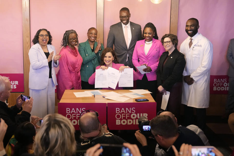 Michigan Gov. Gretchen Whitmer holds up signed legislation that repeals the 1931 abortion ban statute, which criminalized abortion in nearly all cases during a bill signing ceremony, Wednesday, April 5, 2023, in Birmingham, Mich. The abortion ban, which fueled one of the largest ballot drives in state history, had been unenforceable after voters enshrined abortion rights in the state constitution last November. (AP Photo/Carlos Osorio)