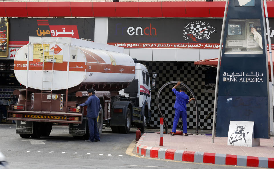 Workers refuel the tank at a gas station in Jiddah, Saudi Arabia, Tuesday, Sept. 17, 2019. U.S. President Donald Trump declared Monday that it "looks" like Iran was behind the explosive attack on Saudi Arabian oil facilities. He stressed that military retaliation was not yet on the table in response to the strike against a key U.S. Mideast ally. (AP Photo/Amr Nabil)