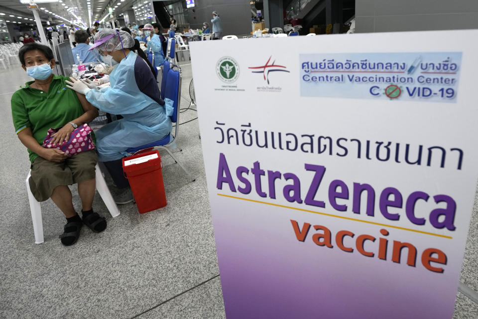 A health worker administers a dose of the AstraZeneca COVID-19 vaccine to a woman at Central Vaccination Center in Bangkok, Thailand, Wednesday, July 14, 2021. Health authorities in Thailand said Wednesday they will seek to put limits on the export of locally produced AstraZeneca vaccine, as the country’s supplies of COVID-19 vaccines are falling short of what is needed for its own population. (AP Photo/Sakchai Lalit)