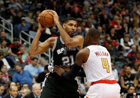 Dec 12, 2015; Atlanta, GA, USA; San Antonio Spurs center Tim Duncan (21) makes a move against Atlanta Hawks forward Paul Millsap (4) in the third quarter of their game at Philips Arena. The Spurs defeated the Hawks 103-78. Mandatory Credit: Jason Getz-USA TODAY Sports