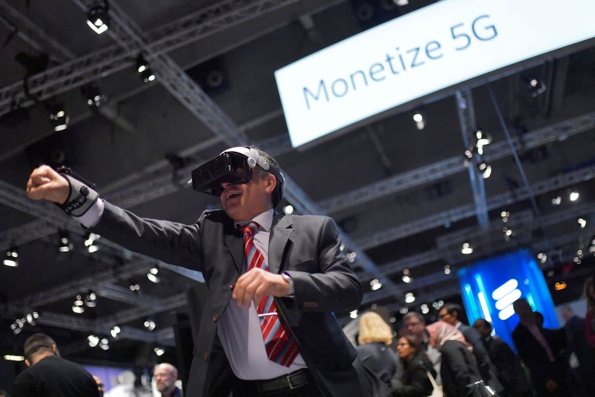 A visitor wears augmented reality glasses at Mobile World Congress (MWC), the telecom industry's biggest annual gathering (Paul Barrna / AFP via Getty Images)