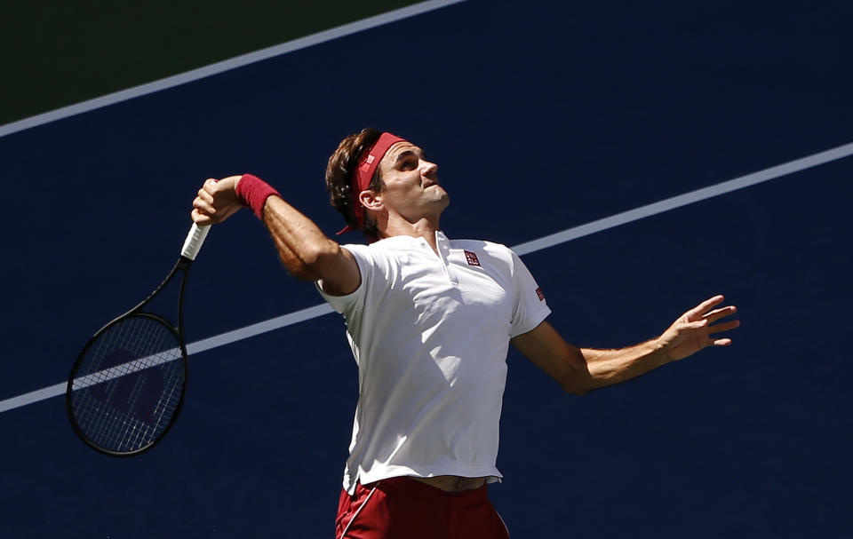 Roger Federer, of Switzerland, serves to Nick Kyrgios, of Australia, during the third round of the U.S. Open tennis tournament, Saturday, Sept. 1, 2018, in New York. (AP Photo/Jason DeCrow)