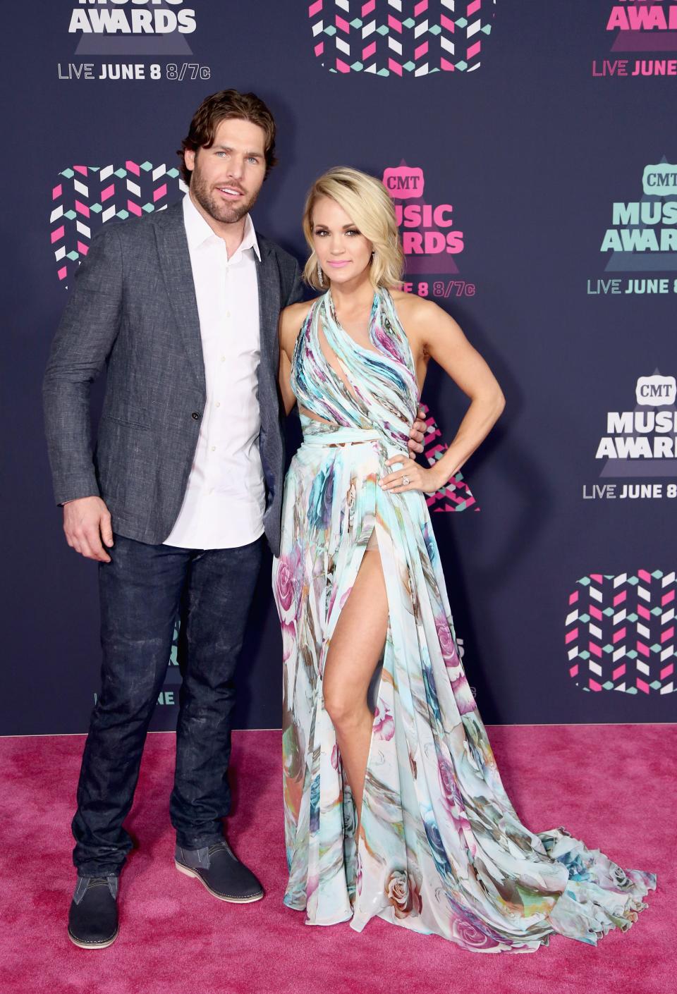 Mike Fisher (L) and Carrie Underwood attend the 2016 CMT Music awards