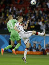 Germany's Per Mertesacker, right, clears the ball ahead of Algeria's Islam Slimani during the World Cup round of 16 soccer match between Germany and Algeria at the Estadio Beira-Rio in Porto Alegre, Brazil, Monday, June 30, 2014. (AP Photo/Kirsty Wigglesworth)