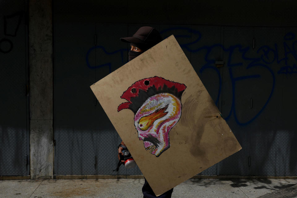 <p>A demonstrator holding a rudimentary shield, poses for a picture before a rally against Venezuelan President Nicolas Maduro’s government in Caracas, Venezuela, May 27, 2017. He said: “I protest for my future, for the future of my country and so I can wake up tomorrow without any fighting or dictatorship”. (Photo: Carlos Garcia Rawlins/Reuters) </p>