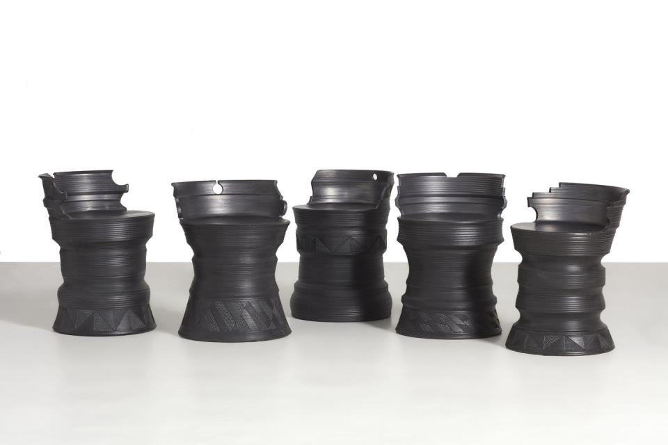 a group of black carved stools