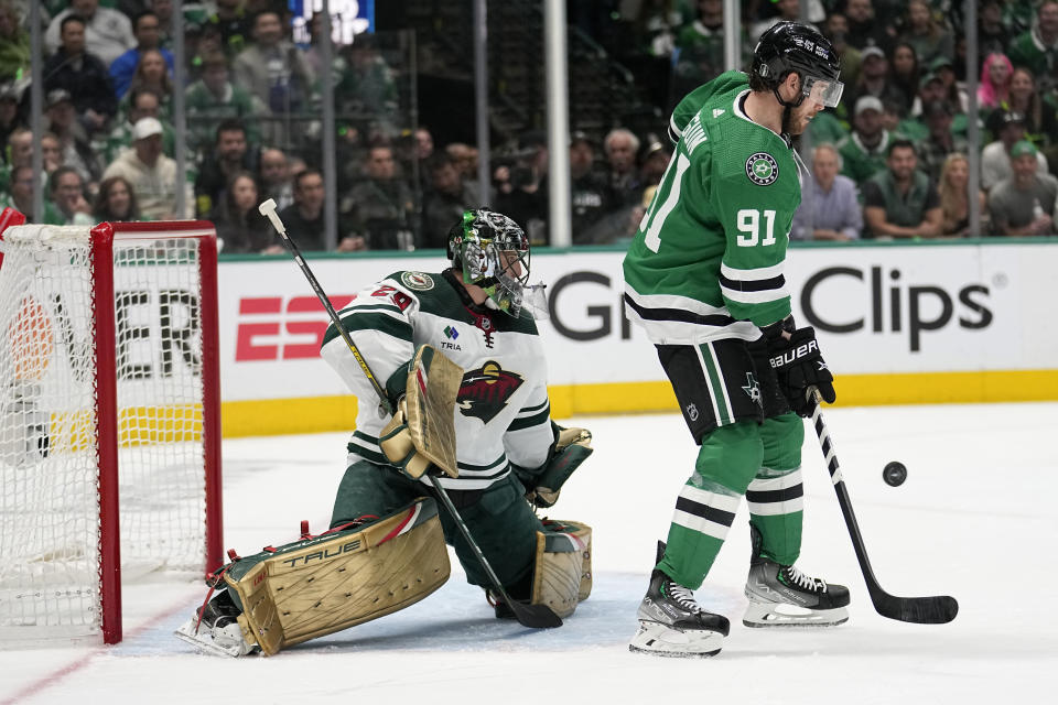 Dallas Stars center Tyler Seguin (91) pressures as Minnesota Wild's Marc-Andre Fleury (29) defends against a shot in the first period of Game 2 of an NHL hockey Stanley Cup first-round playoff series, Wednesday, April 19, 2023, in Dallas. (AP Photo/Tony Gutierrez)