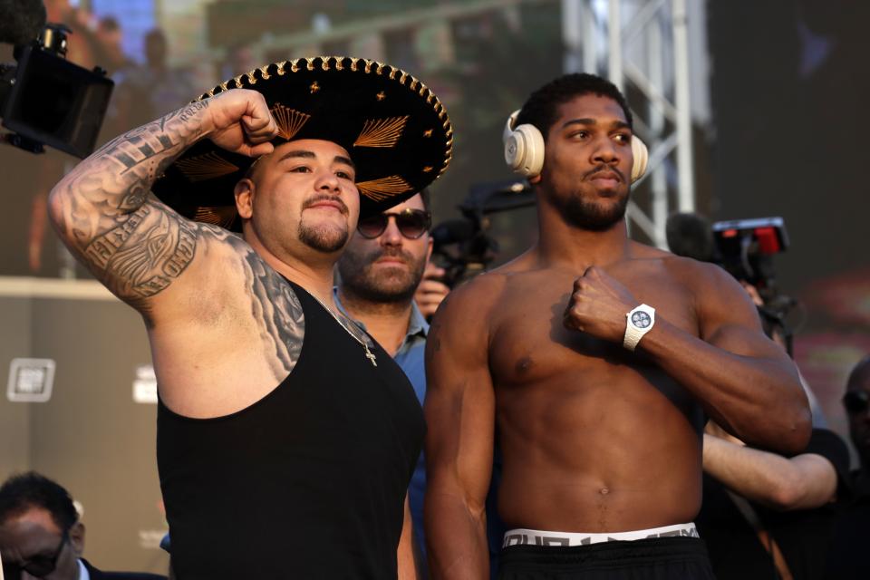 Heavyweight boxers Anthony Joshua of Britain, right, and Andy Ruiz Jr. of Mexico pose during a weigh-in at Faisaliah Center, in Riyadh, Saudi Arabia, Friday, Dec. 6, 2019. The first ever heavyweight title fight in the Middle East, has been called the "Clash on the Dunes." Will take place at the Diriyah Arena on Saturday. (AP Photo/Hassan Ammar)