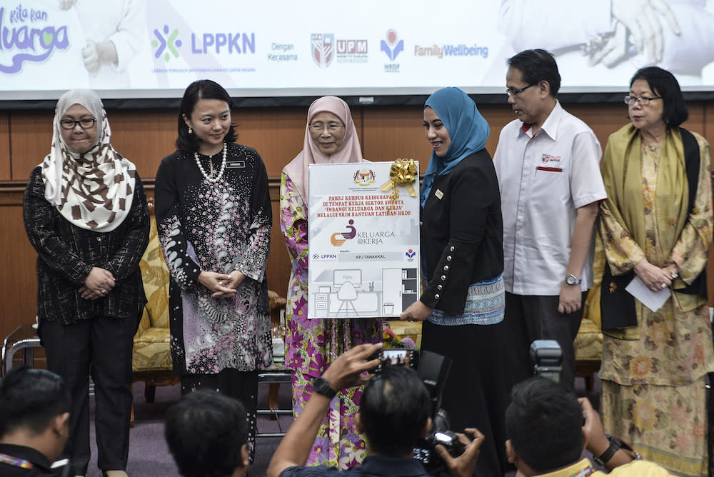 Hannah Yeoh and Dr Wan Azizah Wan Ismail present ‘Parenting@Work’ course packages during Parents’ Day celebrations in Serdang July 13, 2019. — Picture by Shafwan Zaidon